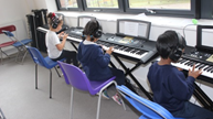 Children playing on keyboards