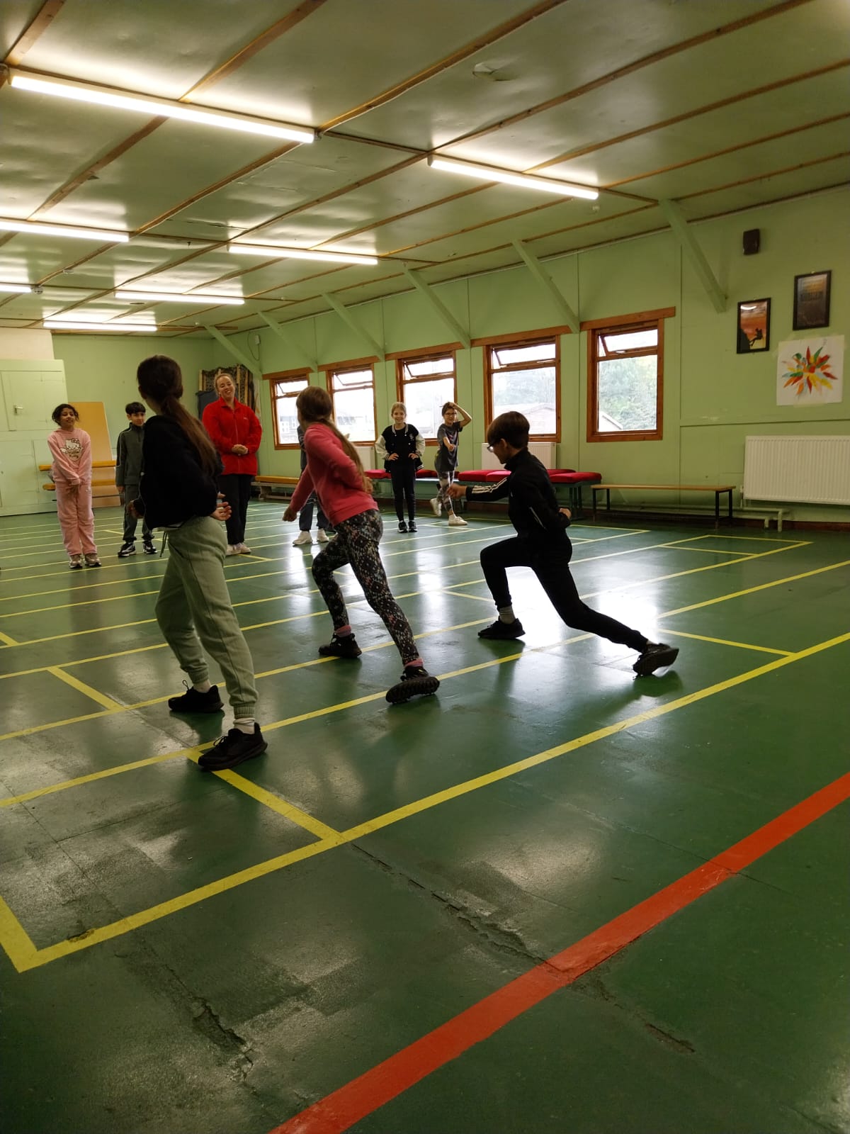 Group of children practicing fencing techniques 