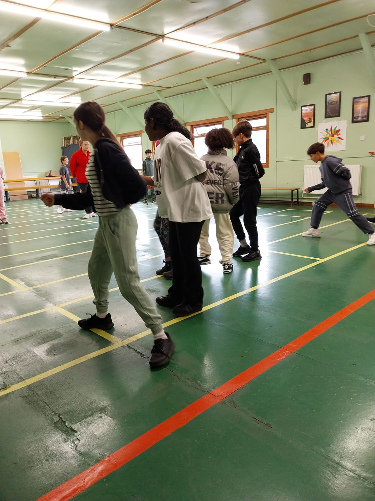 Group of children practicing fencing techniques 