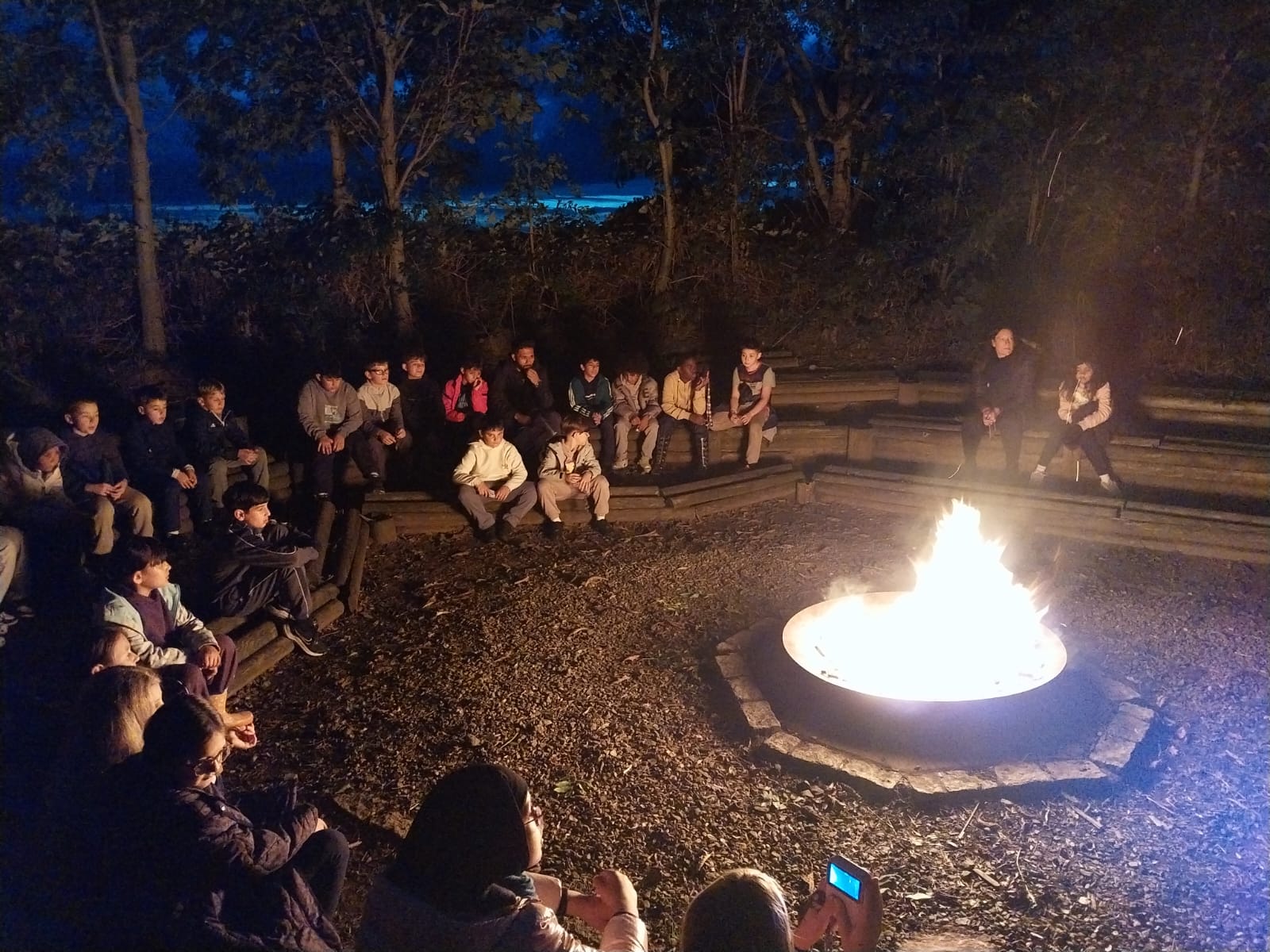 Group of children sat around a campfire