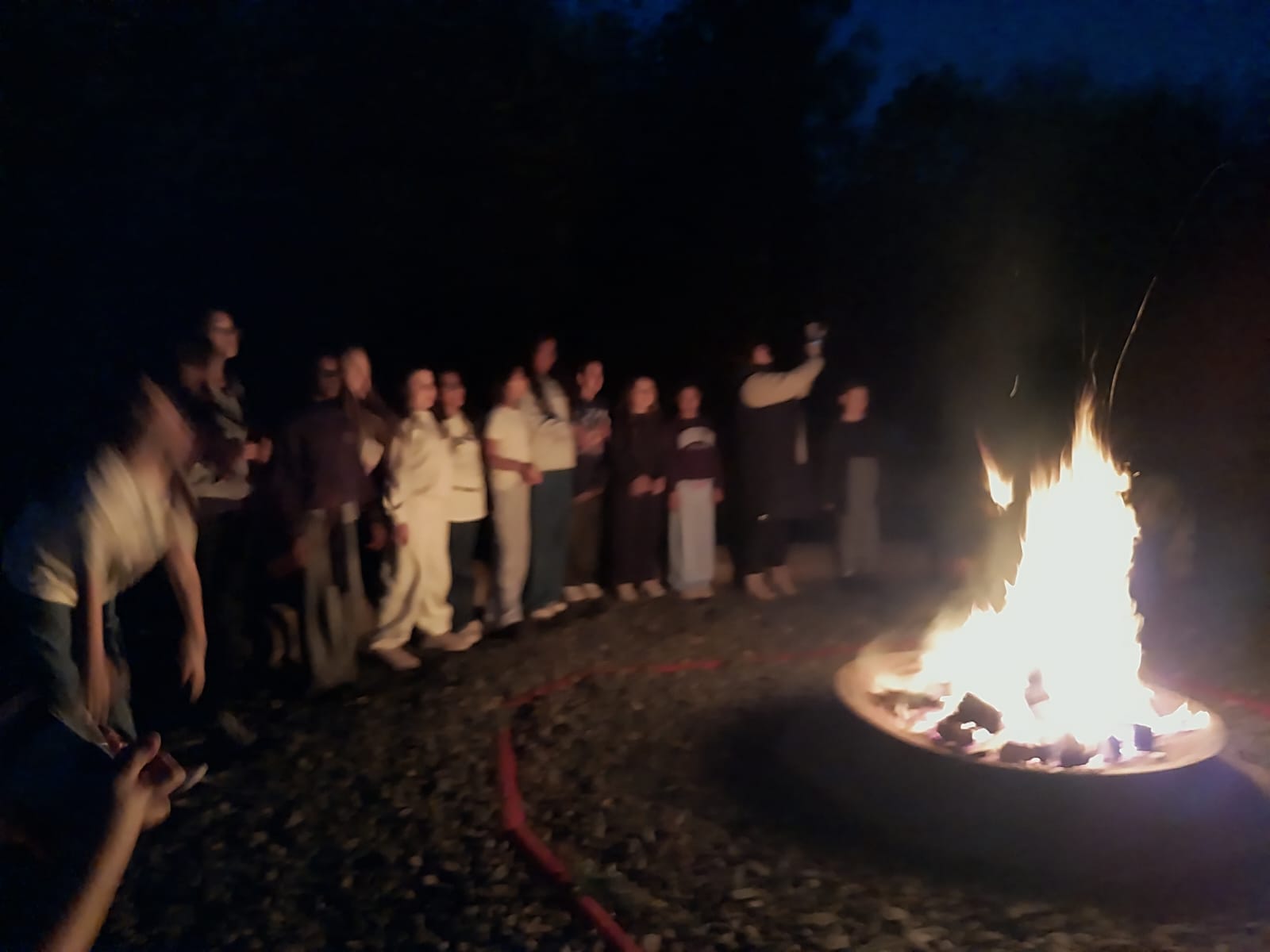 Year 5 & 6 children around a campfire