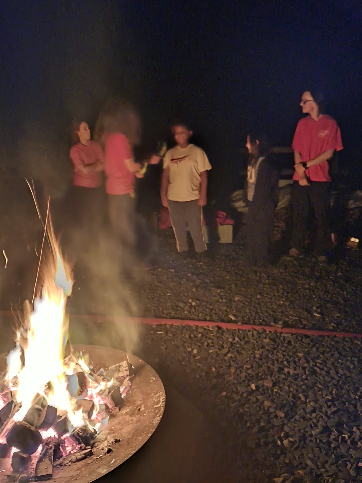 Year 5 & 6 children around a campfire