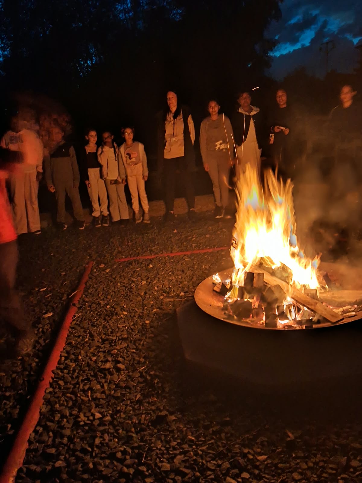 Year 5 & 6 children around a campfire